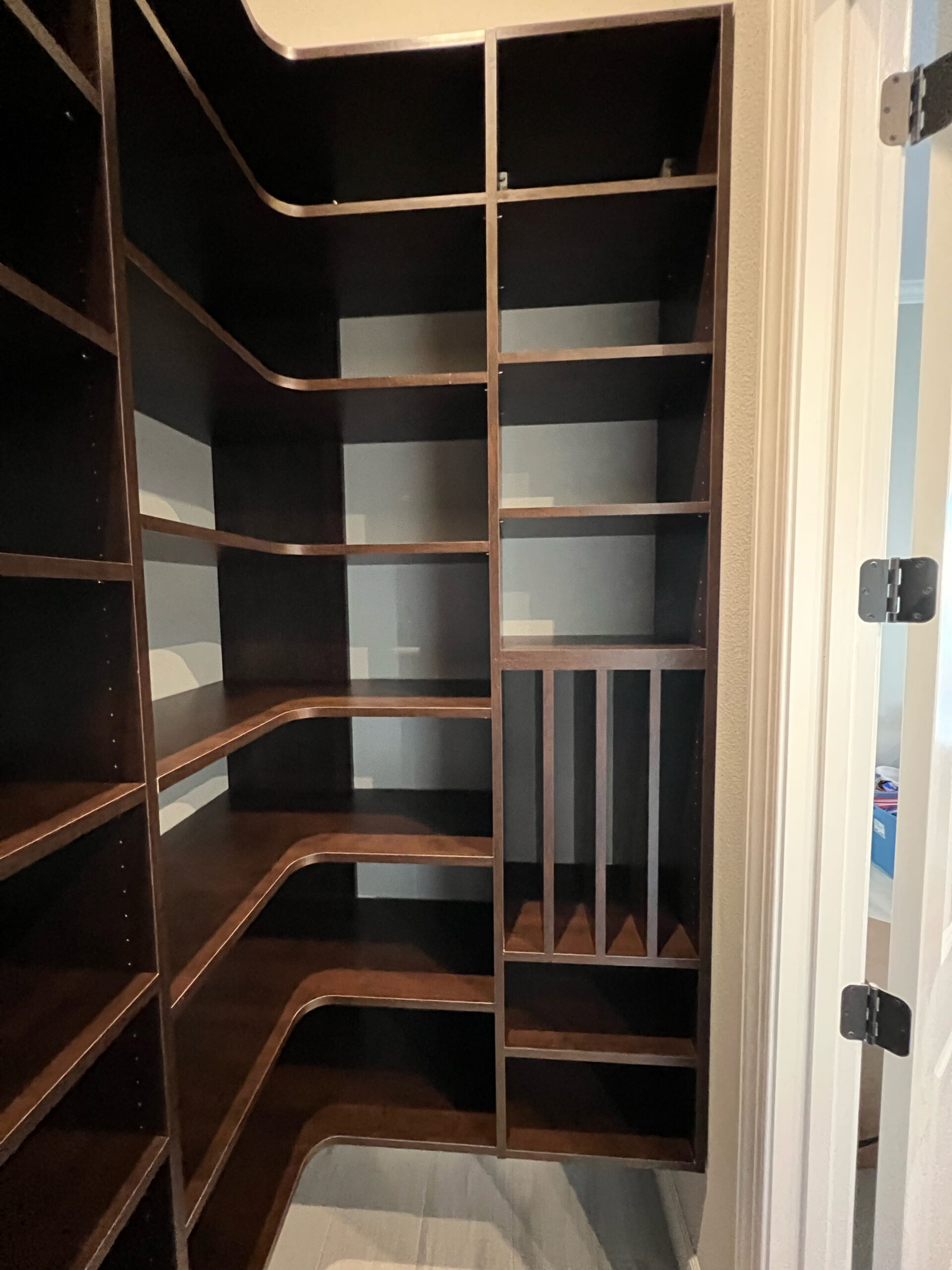 Walk-in pantry with corner shelving