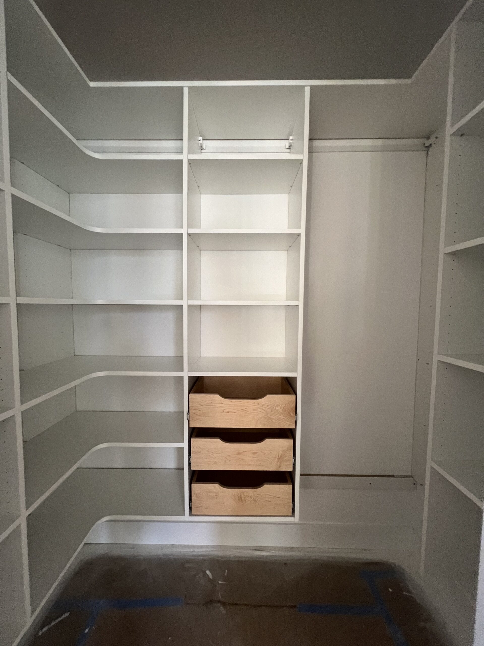 White pantry with wood drawer boxes and pull-out drawers